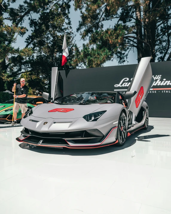 an exotic car sits on the ground of a showroom