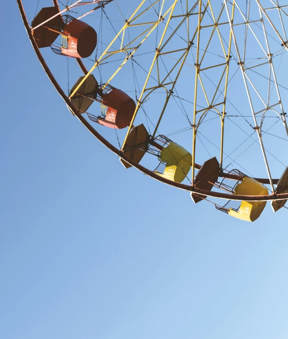 a large ferris wheel with many pieces of yellow plastic