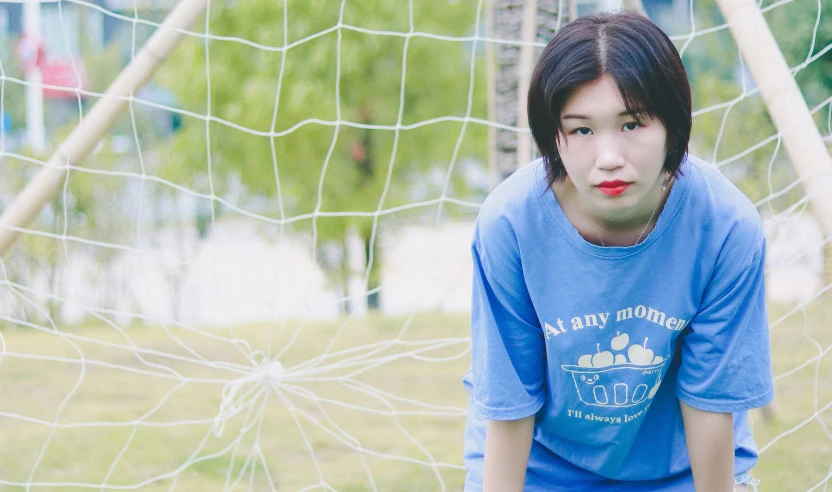 the boy is posing in front of a net