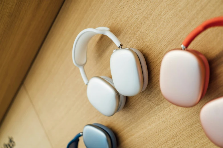 three earphones are hanging on the wall next to each other