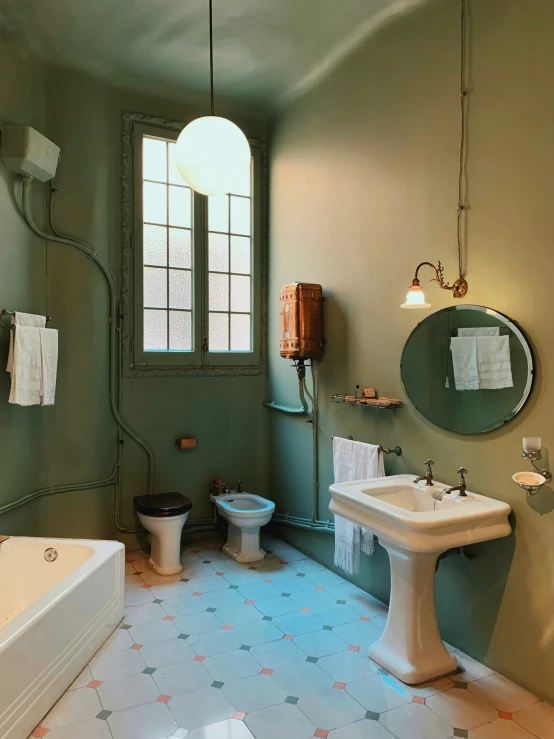 this is a bathroom with blue tiles and green walls