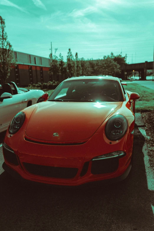 a close up view of the front of an orange sports car