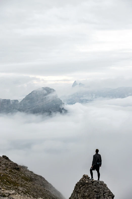 a person on top of a rock overlooking the ocean