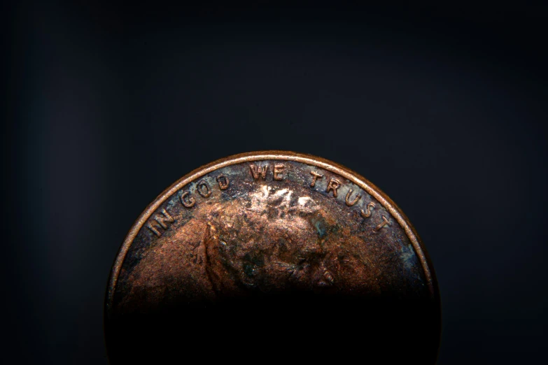 a coin that is half - penny with dark background