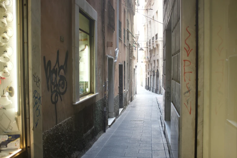 the light shines in on some street that has graffiti