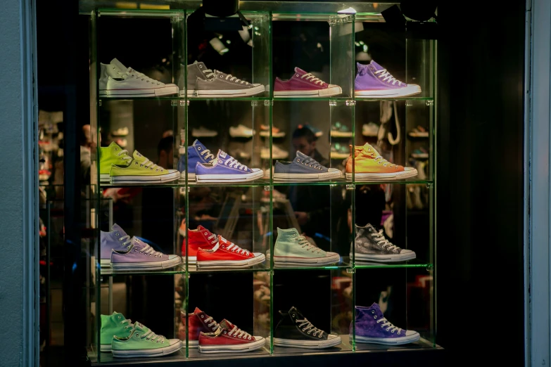 many shoes are displayed in a lighted case