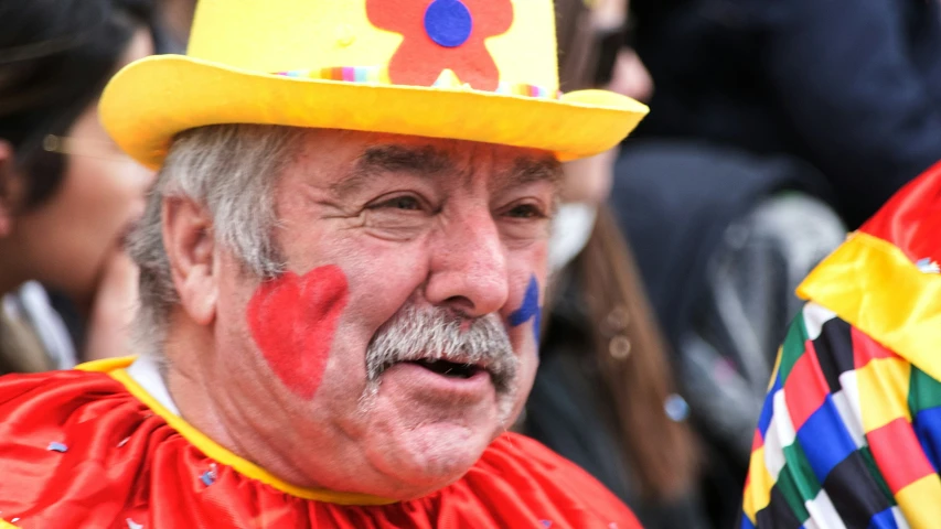 a man with painted face on in a crowd