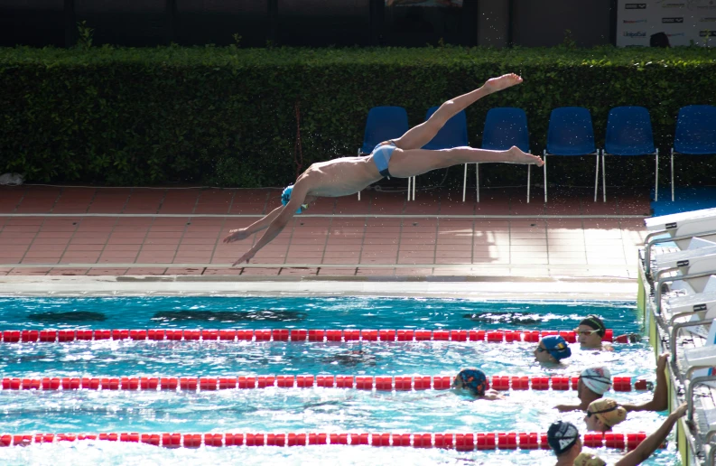 a man is in the water near the edge of a pool