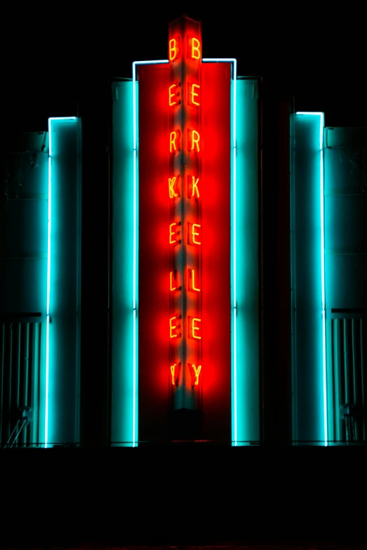 a large neon sign above an entrance way