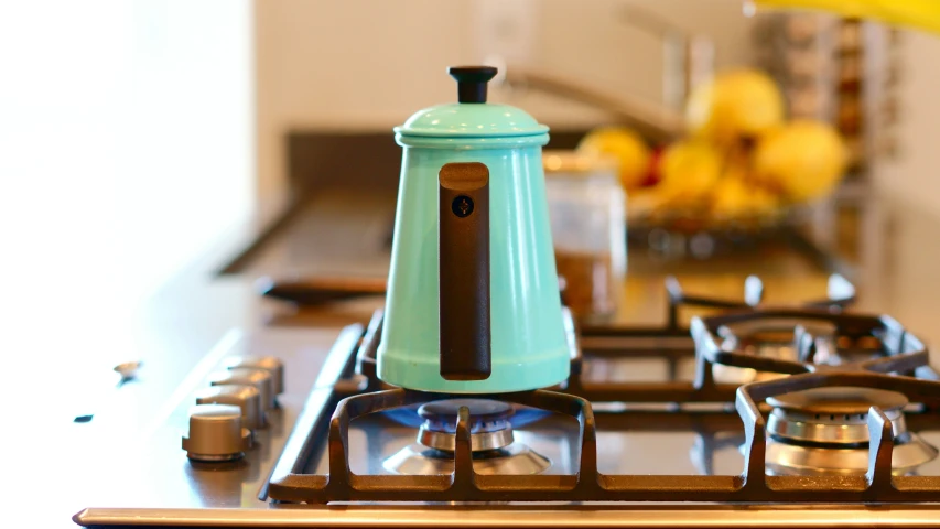 a stove top sitting next to a couple of pots