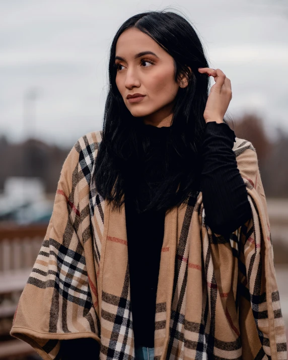 a beautiful young lady dressed up in a cape