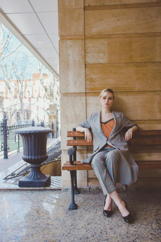 a beautiful woman sitting on top of a bench