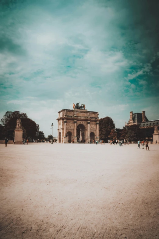 several people are walking around in a large park