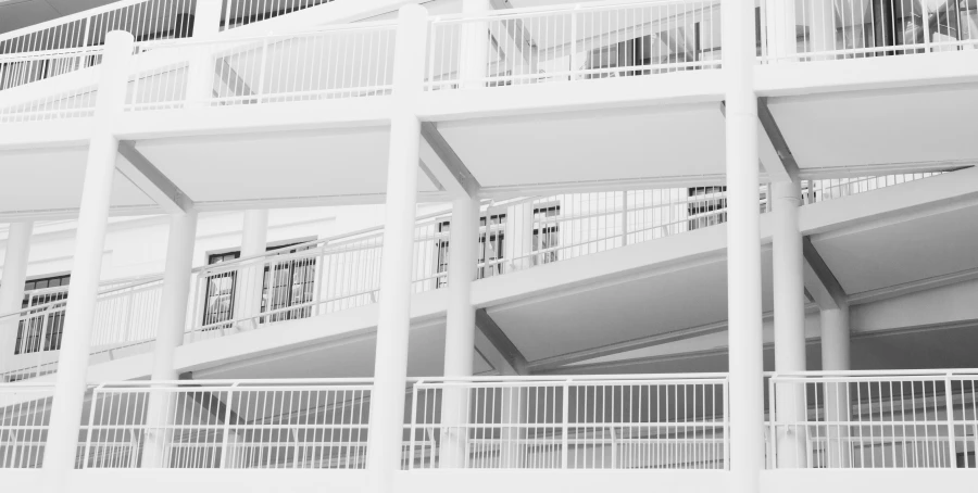 the white walls and balconies of a building with multiple balconies