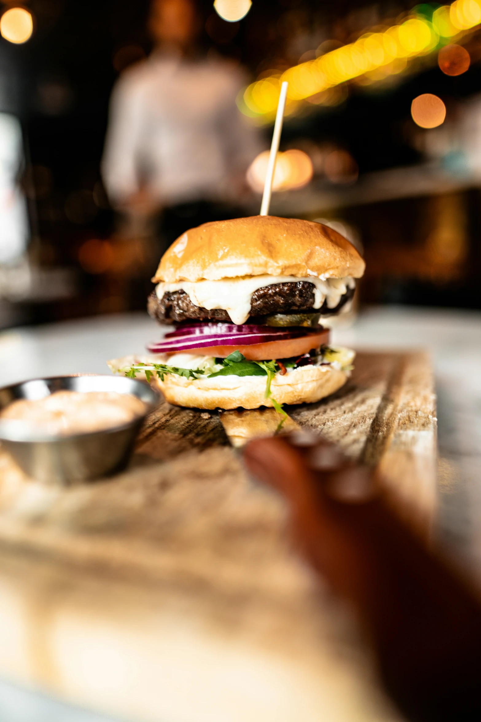 the hamburger is on the table ready to be eaten