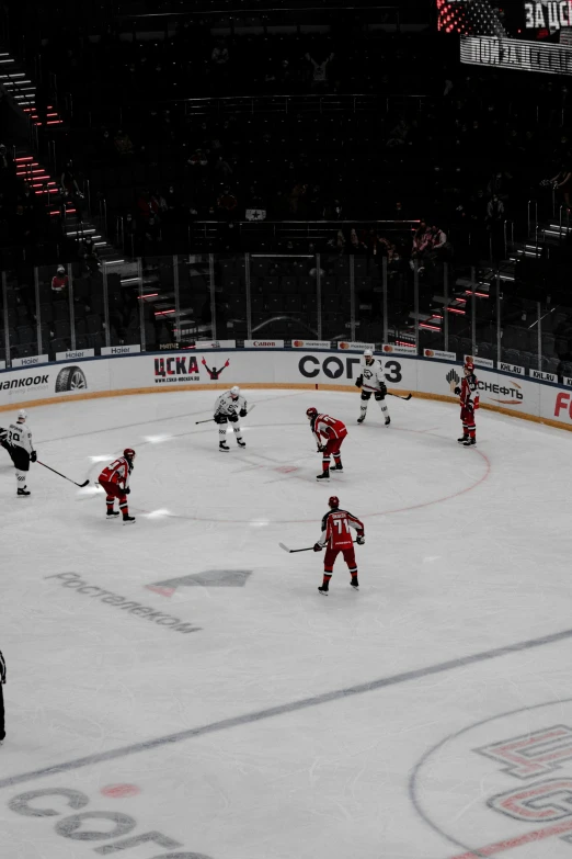 an ice hockey game in progress on an indoor arena