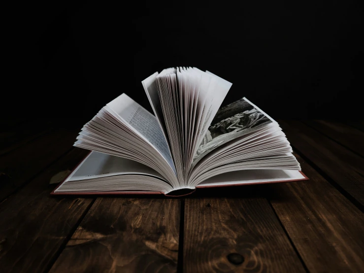 an open book on a wooden table