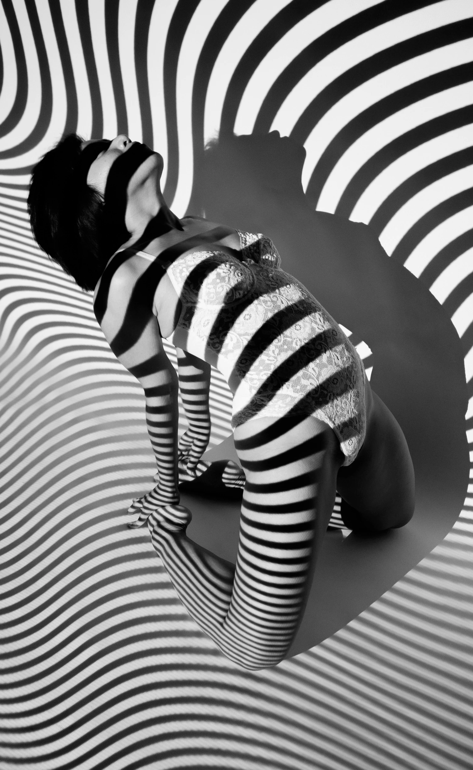 woman wearing stockings and striped tights standing in a room with distorted stripes