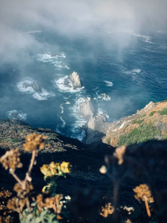 a body of water surrounded by rocky cliffs and greenery