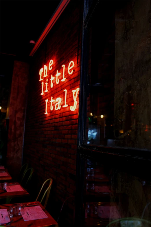 the illuminated sign on the side of a restaurant