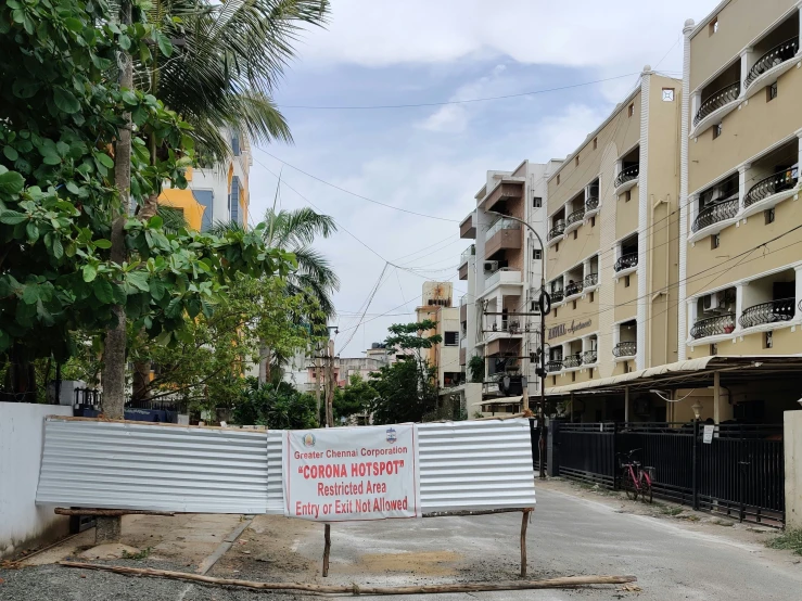 a sign in front of several buildings in a foreign country