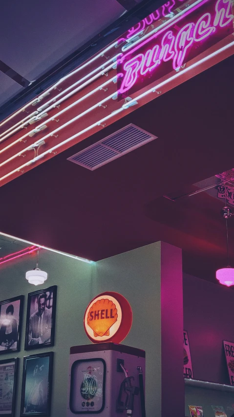 a neon sign hangs above a store called chill shack