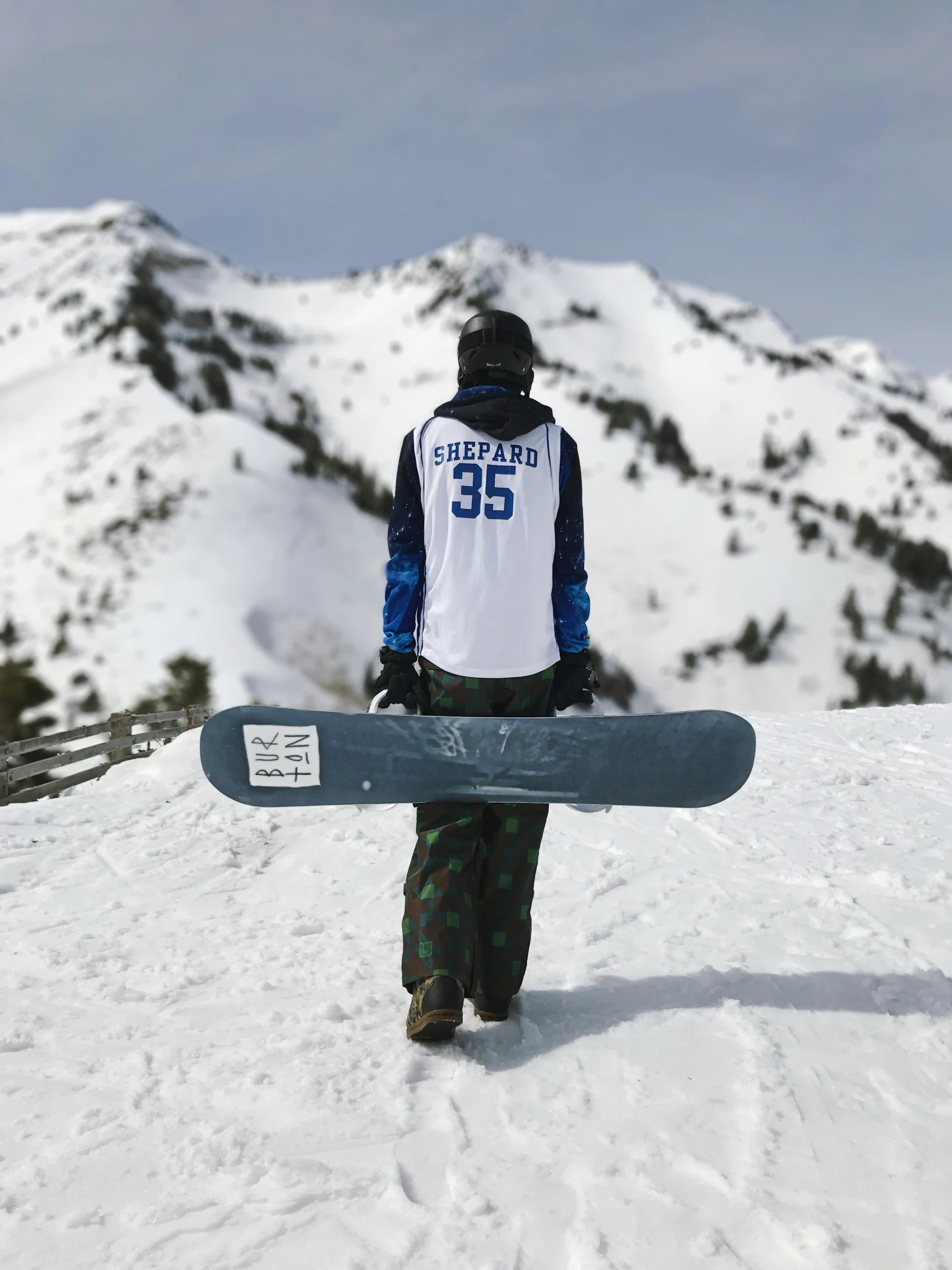 a person in a white shirt holding a blue snowboard