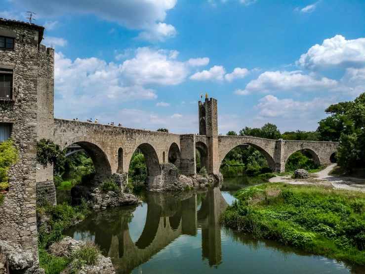 a river is under an old bridge and with arches