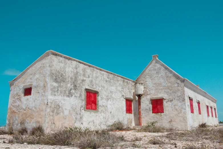 a couple of buildings with two red windows