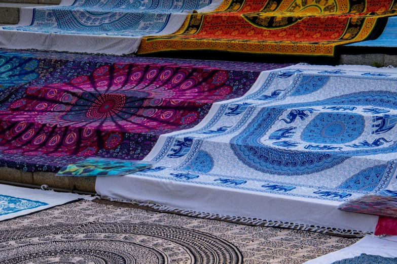 several different patterns on different fabrics displayed with a blue sky in the background