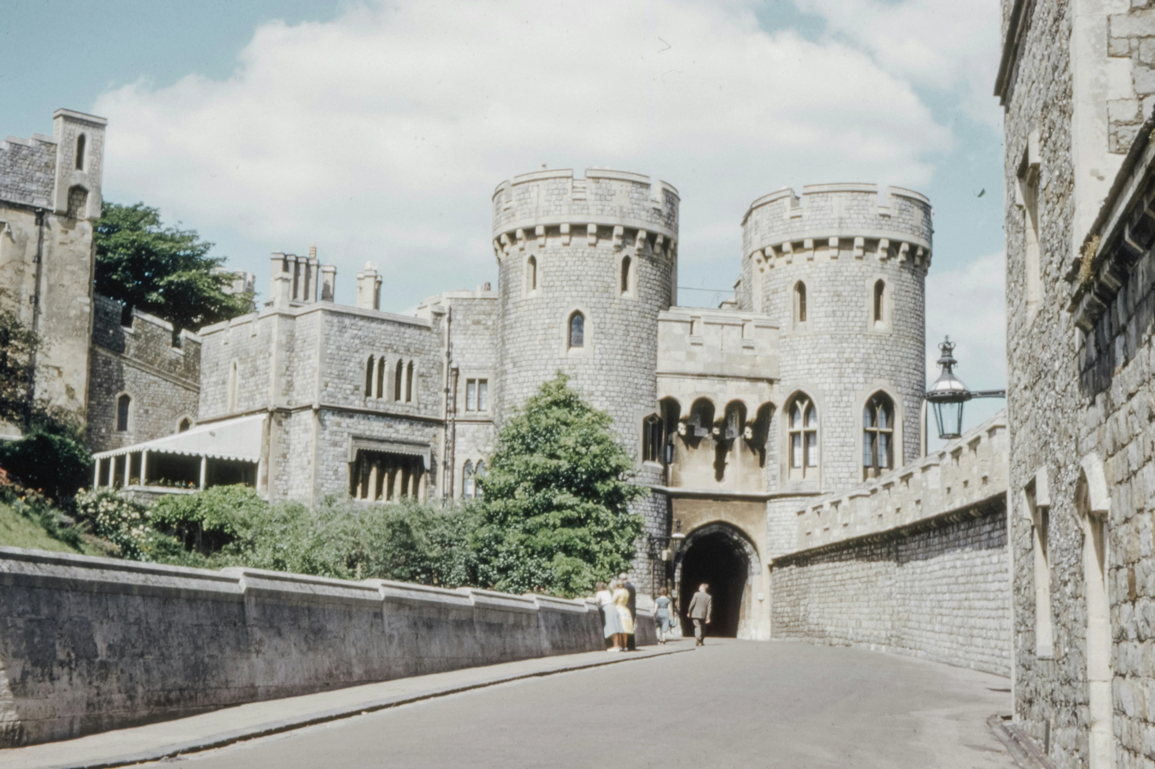 there is a large stone castle on a small street