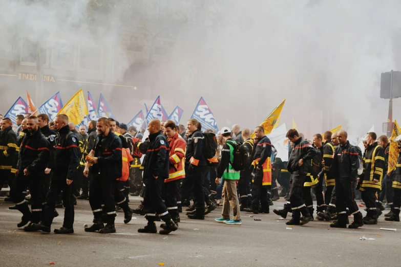 a group of men standing in the street with flags