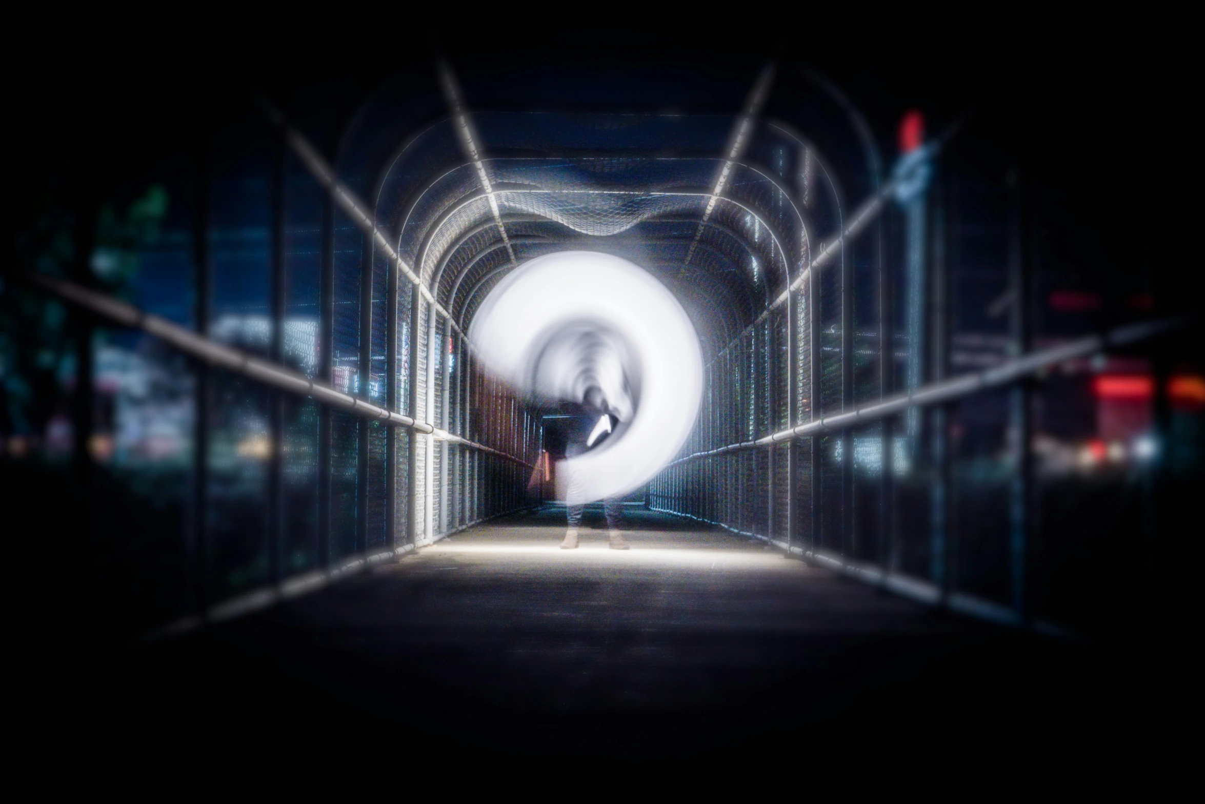 blurry image of person in tunnel near parking lot