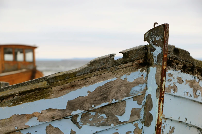 rusted and damaged boats on the beach