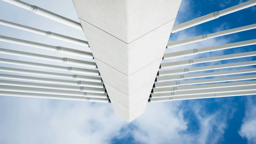 a very tall building with white roof and some sky