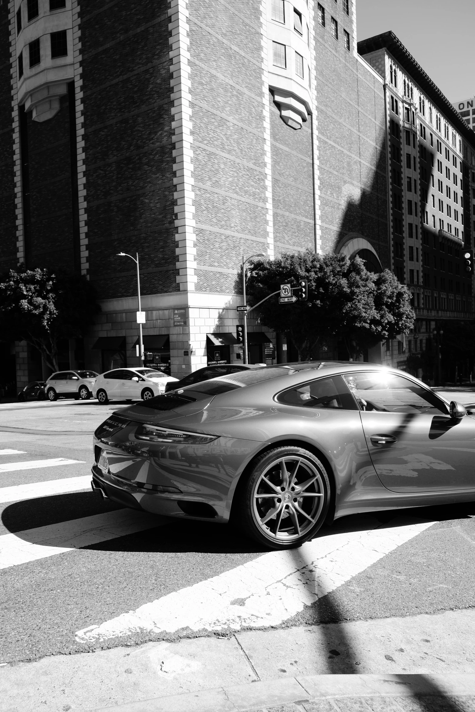 there is a ferrari parked next to a tall building