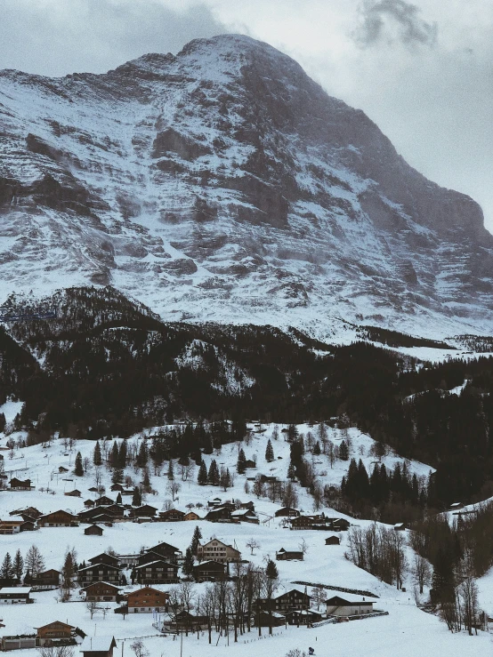 a snowy view of a large mountain with buildings on it