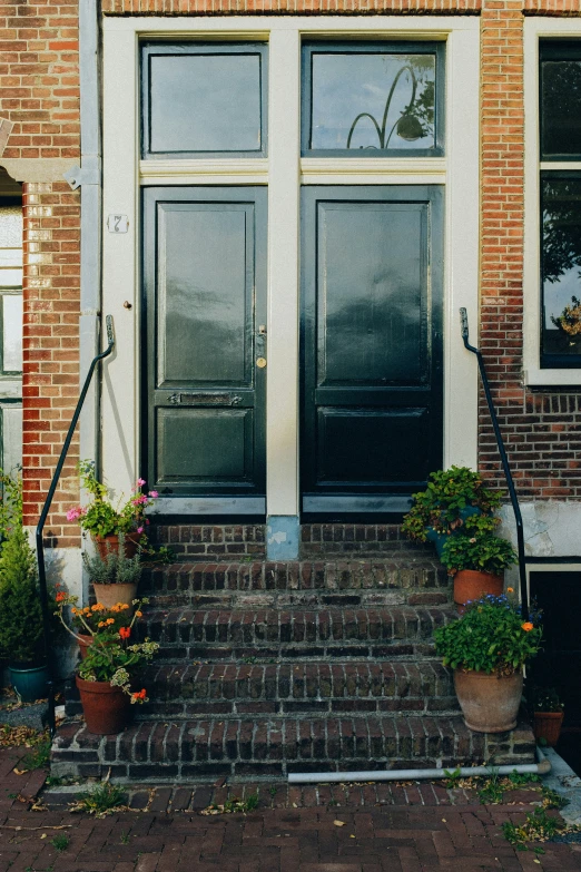 a stairway leading to a brick building next to two open windows