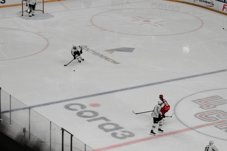 an aerial view of a hockey rink with players and the net