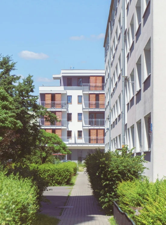 tall buildings sitting along side of a small courtyard