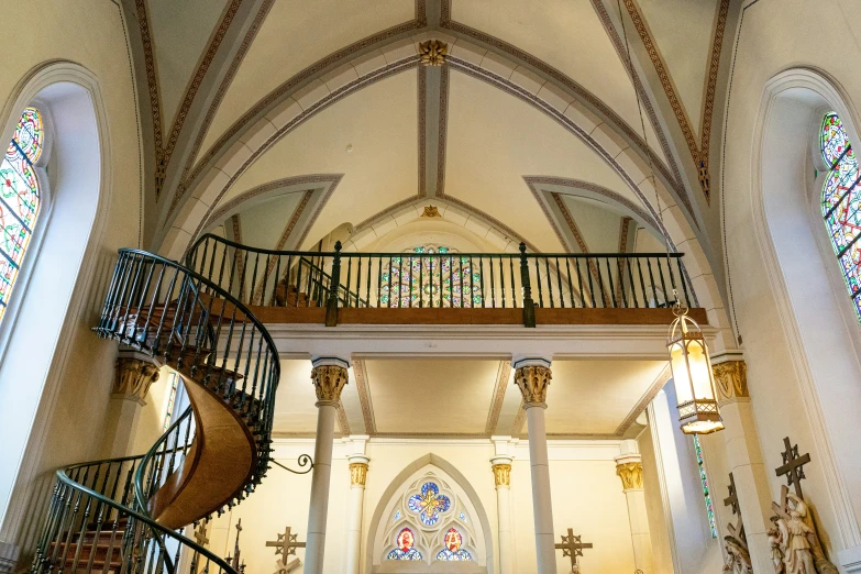 the interior of an elegant church with stained glass windows