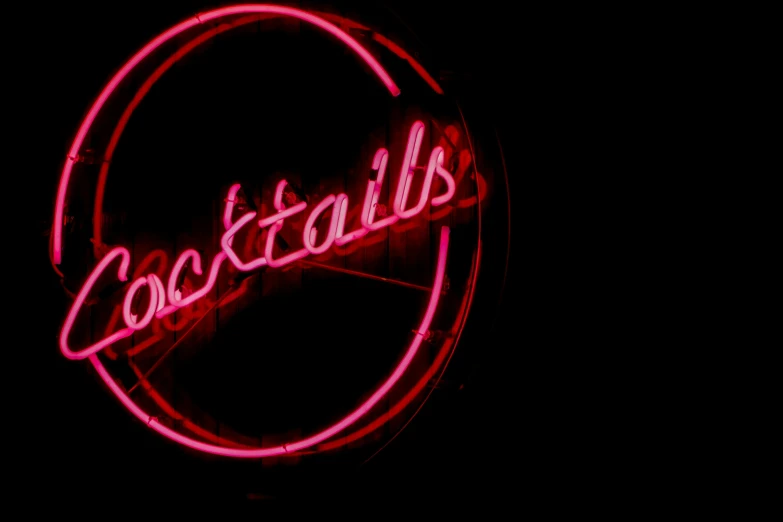 a neon sign that reads coca cola still has it's lights on