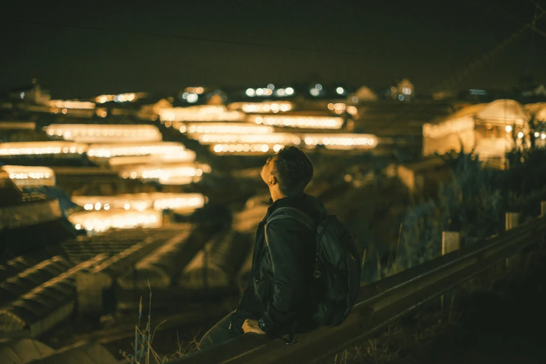 a person standing on a ledge at night