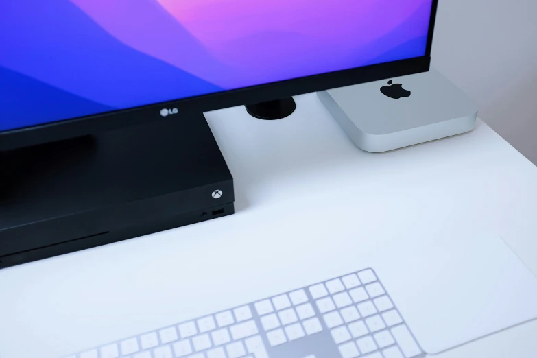 an apple desktop computer sits on a desk