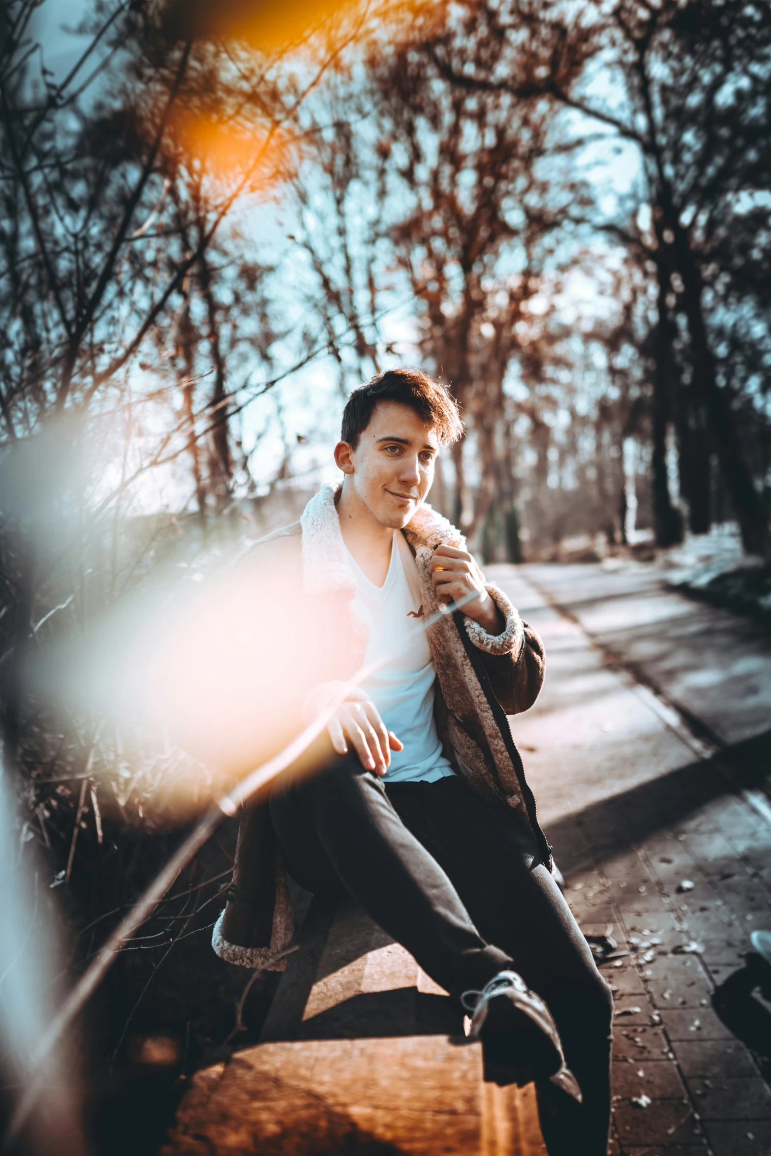 a man sitting on top of a wooden bench