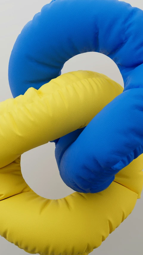 two bright colors, one blue and one yellow donut - type plush toy