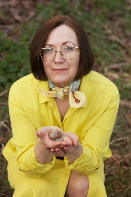 a woman sitting on the ground holding soing in her hands