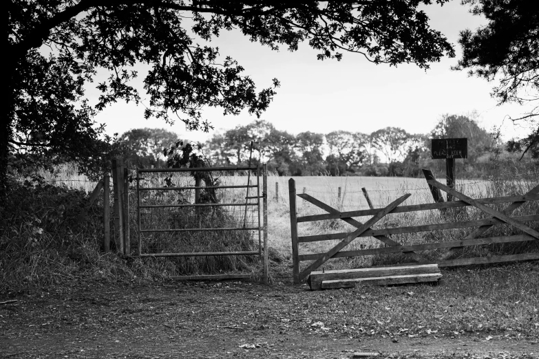 a gate in the middle of a large field