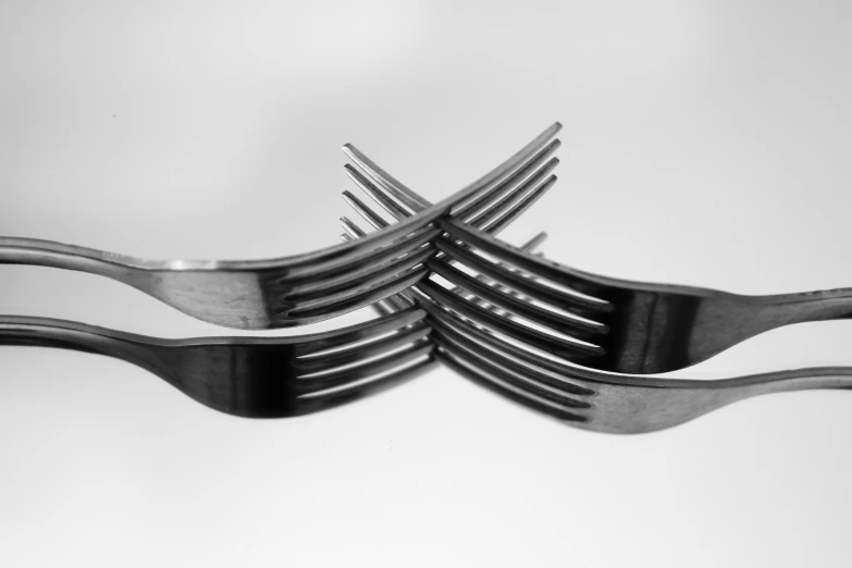 several forks with two sides are stacked in different angles