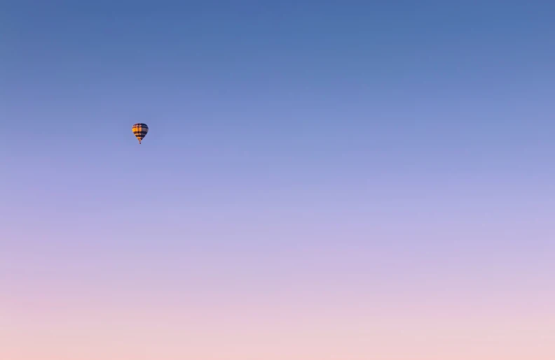 a  air balloon flying high in the sky